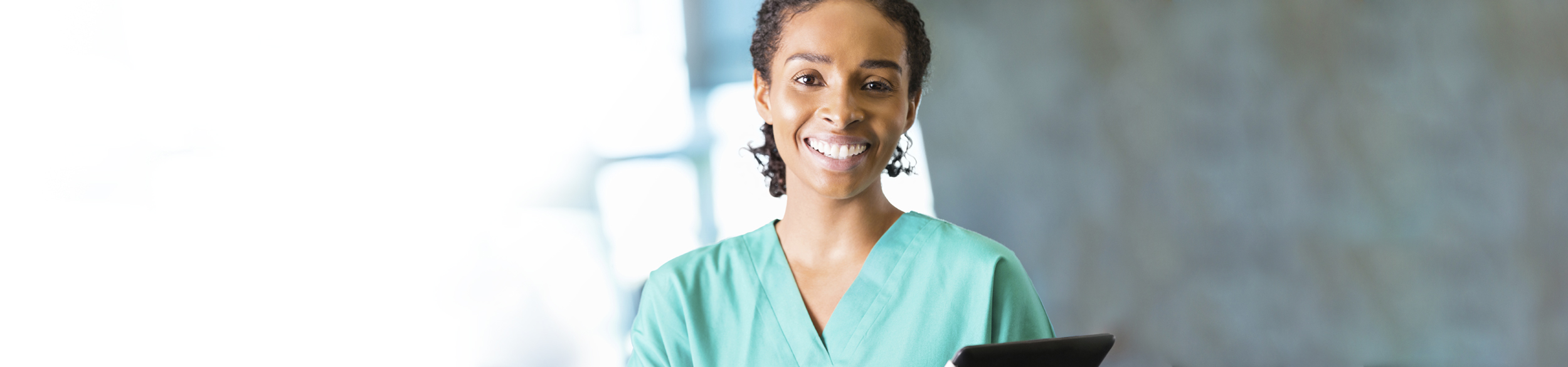 Medical Assistant smiling and holding a clip board